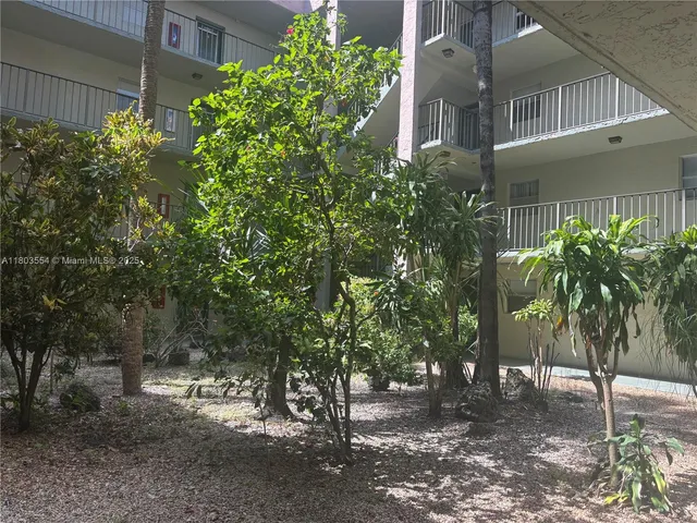 a view of a house with a tree