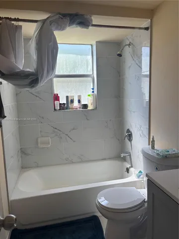 a bathroom with a sink a toilet and a bathtub