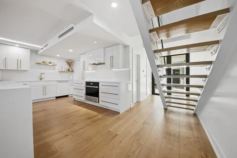 a view of a kitchen with microwave and cabinets