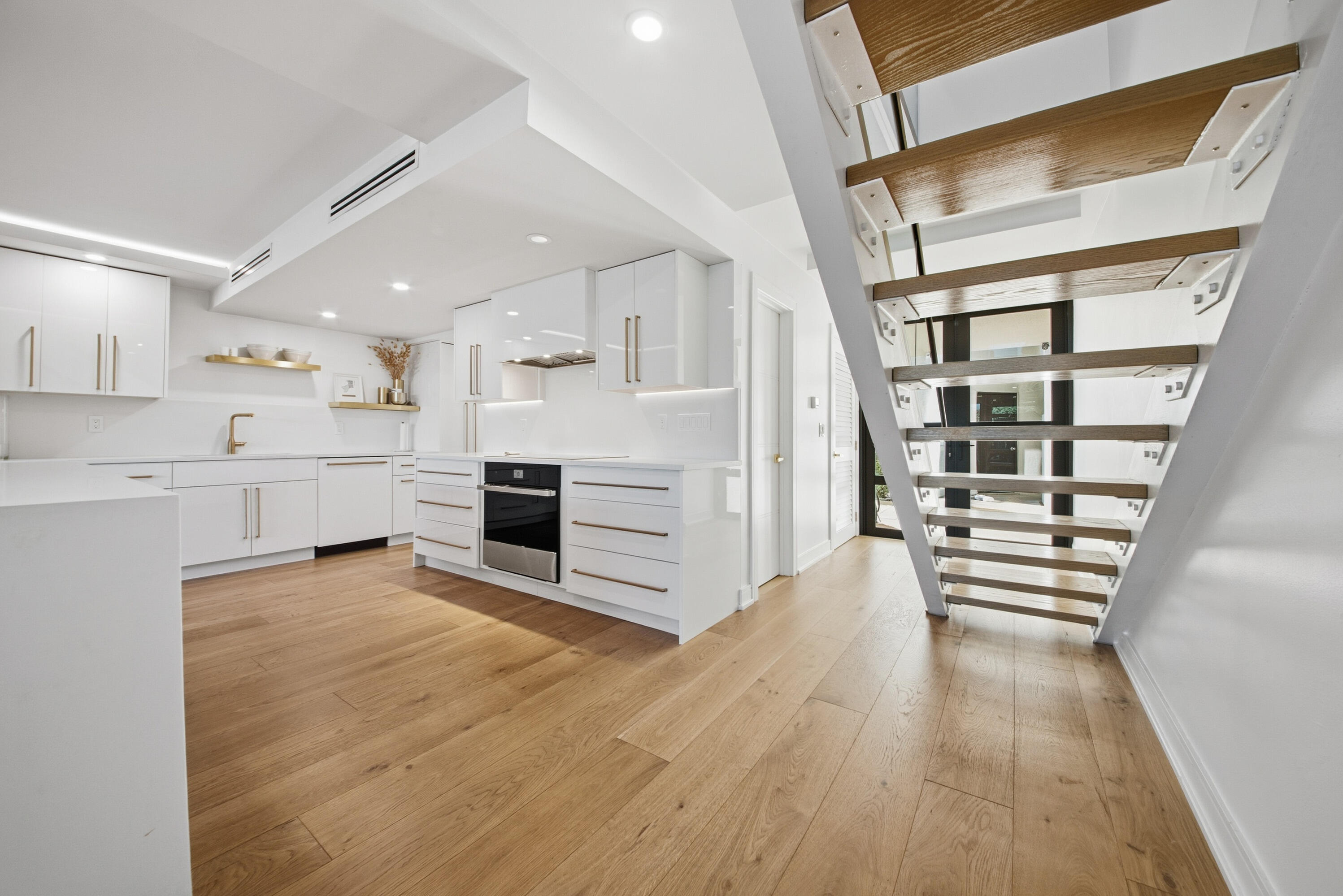 800 North Ocean Boulevard, Unit 4 Delray Beach, FL 33483 - Photo 10 of 30 a view of a kitchen with wooden floor and electronic appliances