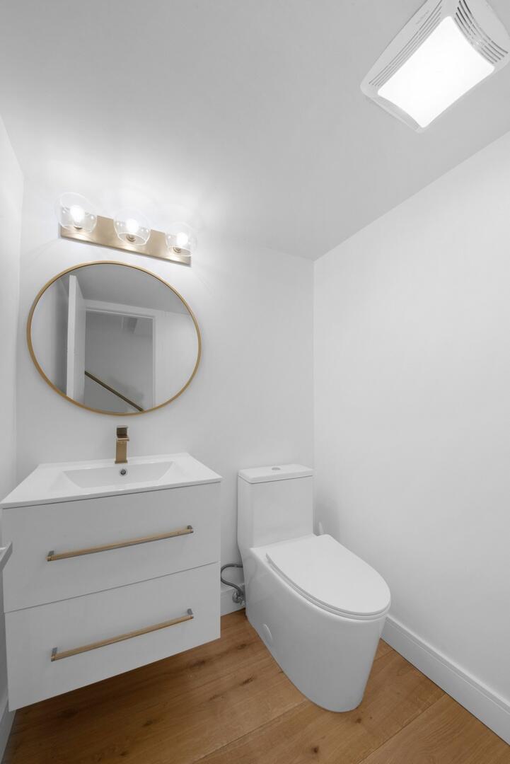 800 North Ocean Boulevard, Unit 4 Delray Beach, FL 33483 - Photo 12 of 30 a bathroom with a sink mirror vanity and toilet