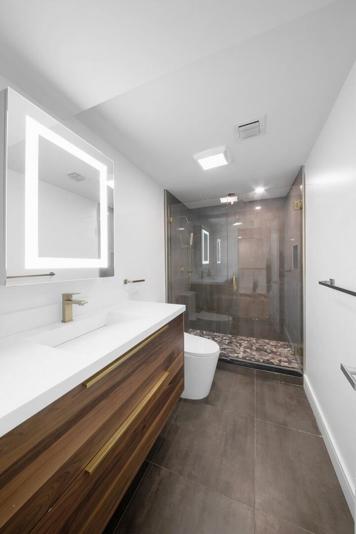 800 North Ocean Boulevard, Unit 4 Delray Beach, FL 33483 - Photo 21 of 30 a bathroom with a sink a toilet and a bathtub