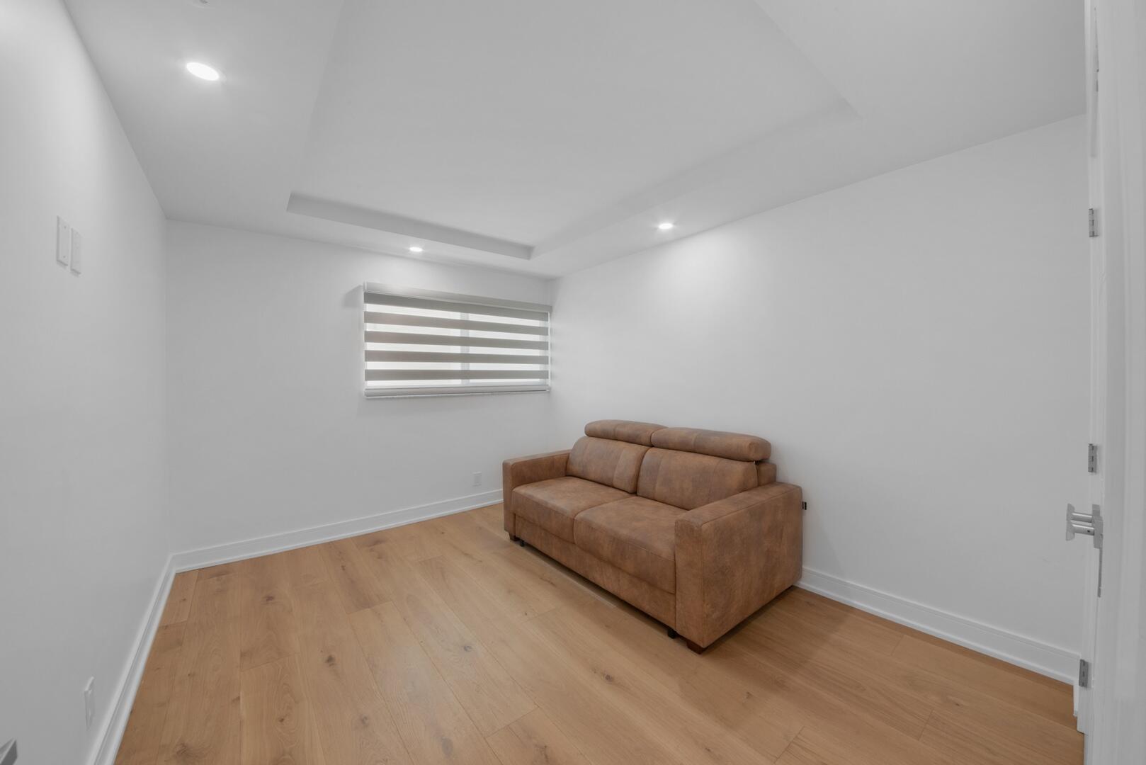 800 North Ocean Boulevard, Unit 4 Delray Beach, FL 33483 - Photo 22 of 30 a room with furniture and a window