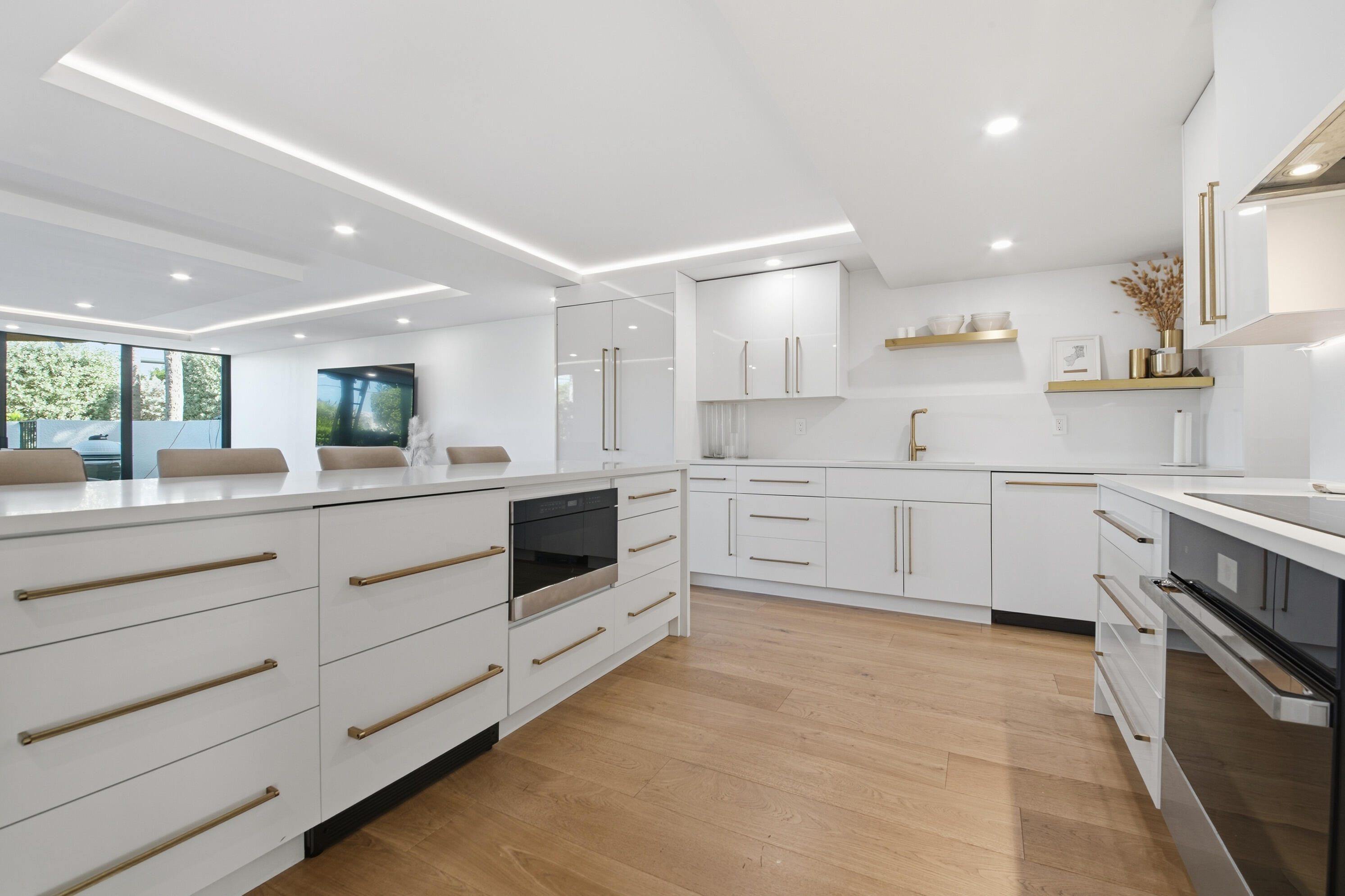 800 North Ocean Boulevard, Unit 4 Delray Beach, FL 33483 - Photo 6 of 30 a kitchen with stainless steel appliances granite countertop white cabinets and wooden floors
