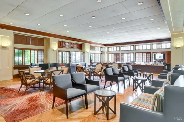 a living room with lots of furniture and a large window