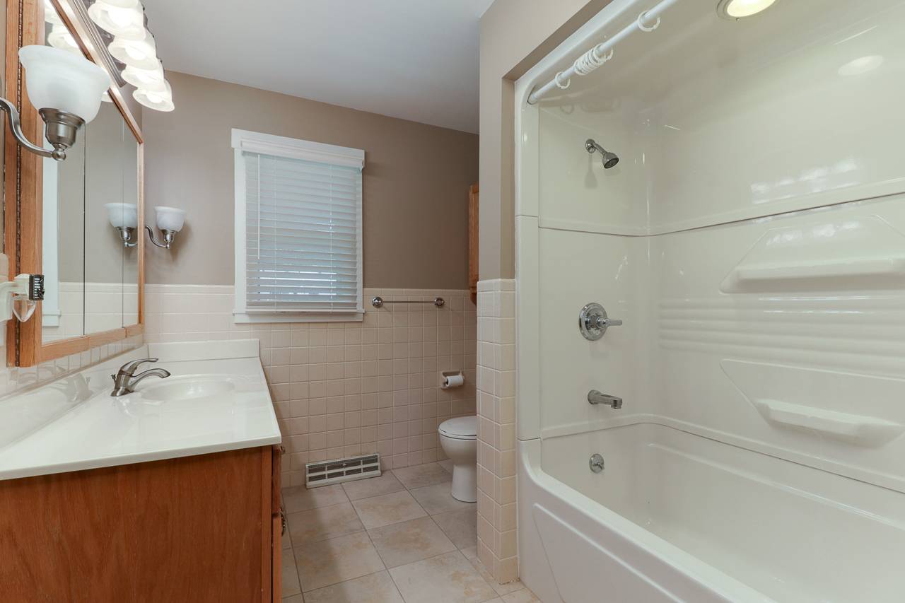 24 Ardith Drive Normal, IL 61761 - Photo 15 of 30 a bathroom with a bathtub shower sink vanity and toilet