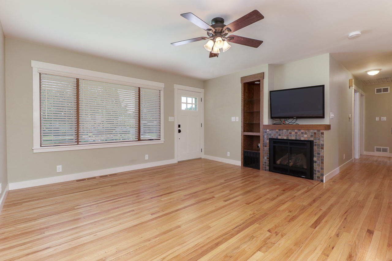 24 Ardith Drive Normal, IL 61761 - Photo 3 of 30 a view of a livingroom with a fireplace a ceiling fan and wooden floor