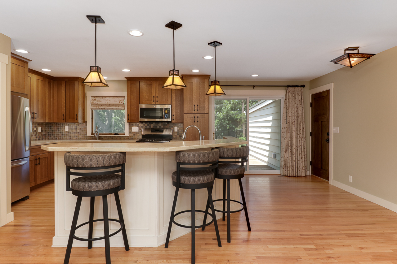 24 Ardith Drive Normal, IL 61761 - Photo 4 of 30 a kitchen with stainless steel appliances granite countertop a stove top oven a sink a dining table and chairs with wooden floor