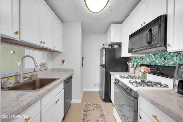 a view of a dining room with furniture and a chandelier