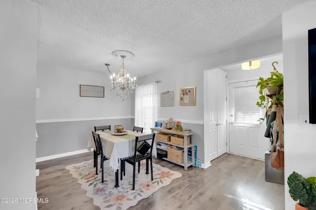 a view of a dining room with furniture and chandelier