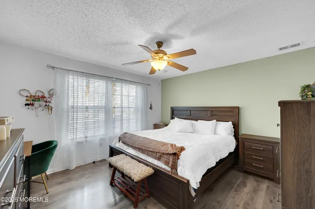 a bathroom with a sink vanity mirror and toilet
