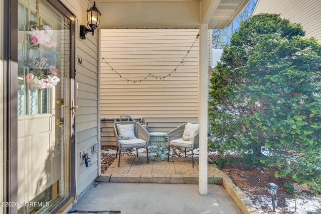 a view of a patio with table and chairs and potted plants