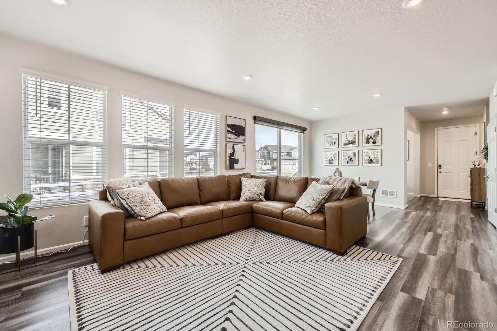 5142 Bittercress Road Brighton, CO 80640 - Photo 2 of 11 a living room with furniture and a large window