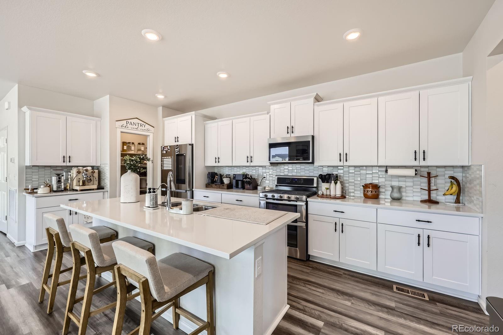 5142 Bittercress Road Brighton, CO 80640 - Photo 3 of 11 a kitchen with appliances a sink and cabinets