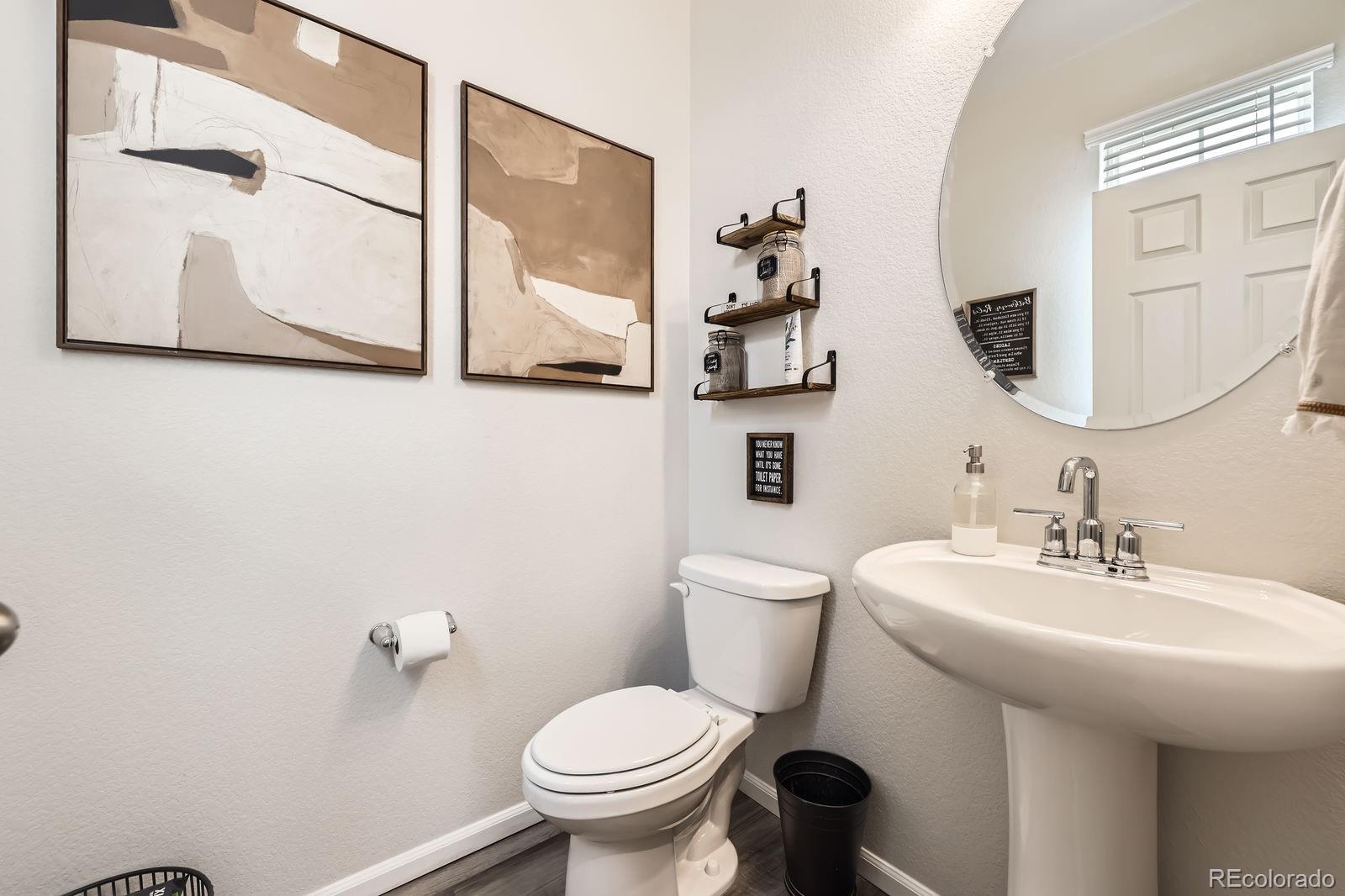 5142 Bittercress Road Brighton, CO 80640 - Photo 6 of 11 a bathroom with a toilet sink and mirror