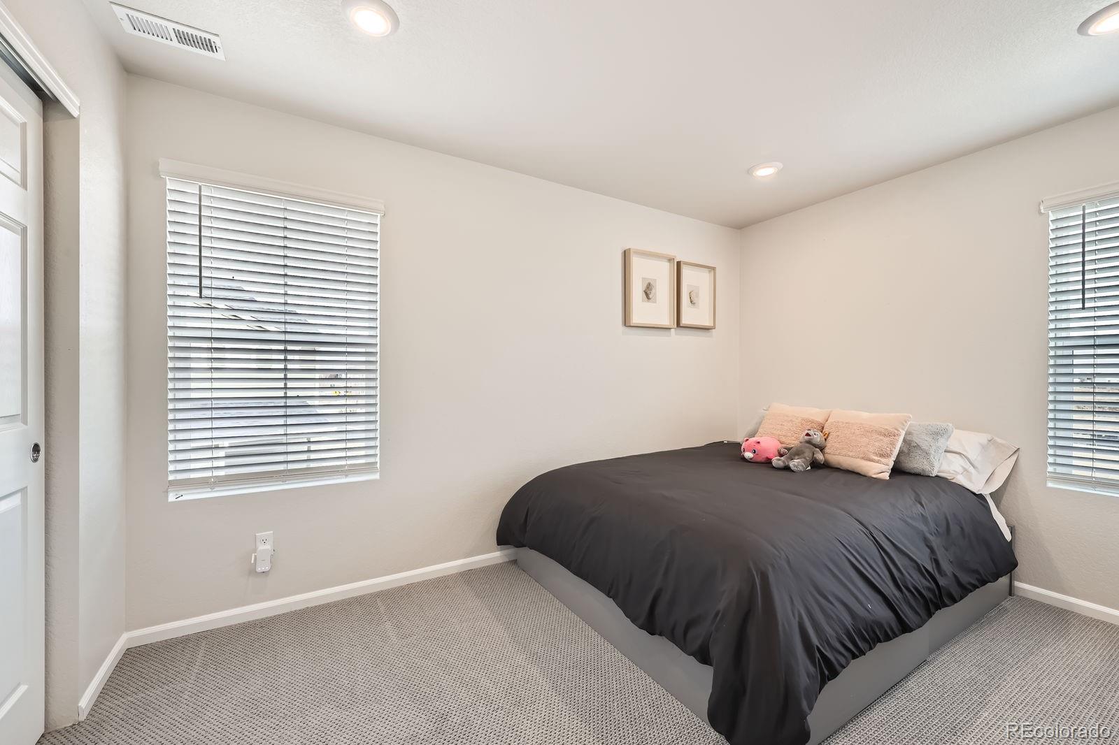 5142 Bittercress Road Brighton, CO 80640 - Photo 9 of 11 a bedroom with a bed and a window