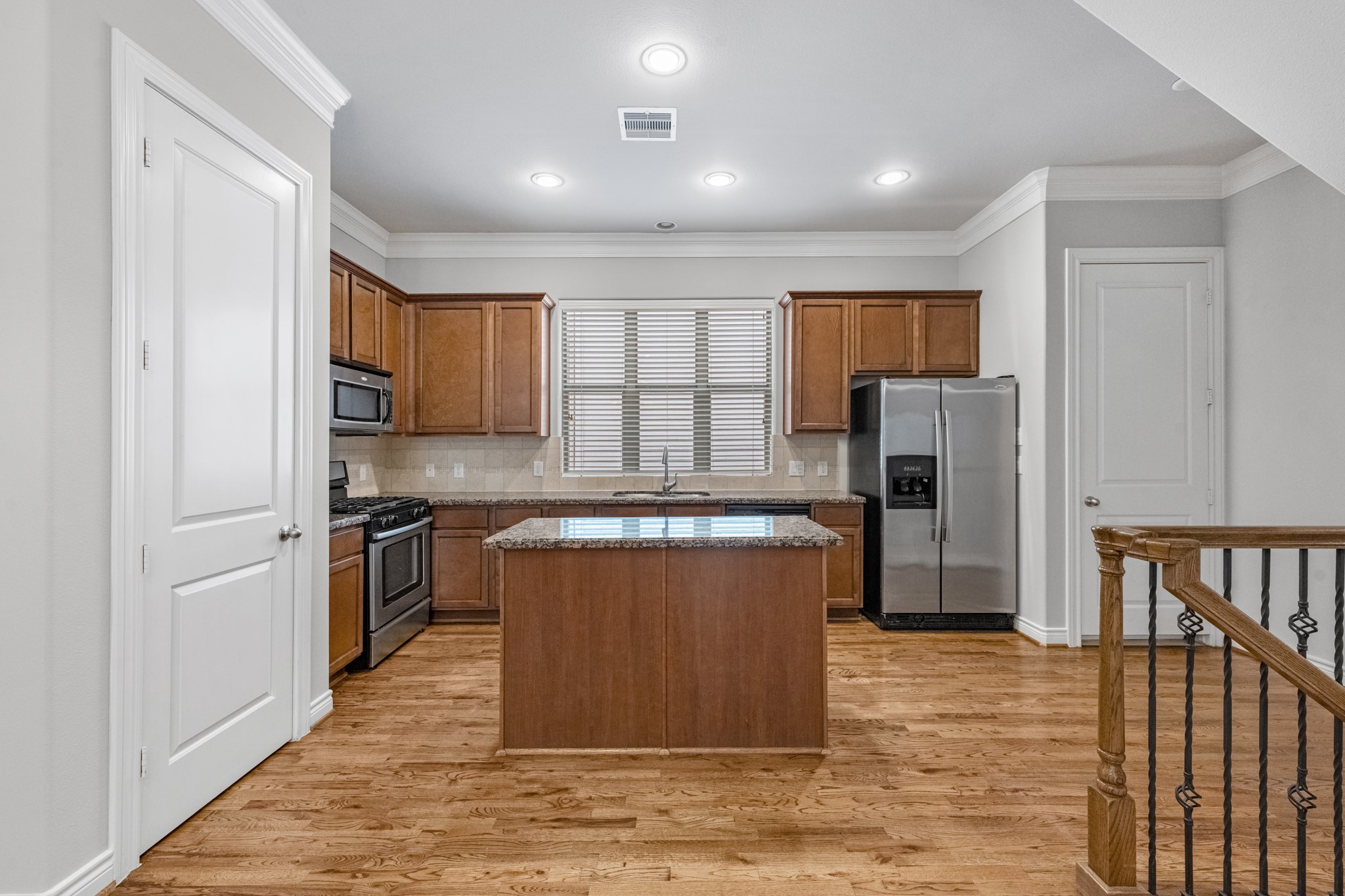 3414 Center Street Houston, TX 77007 - Photo 13 of 35 a kitchen with stainless steel appliances granite countertop a refrigerator a sink a stove a microwave and island