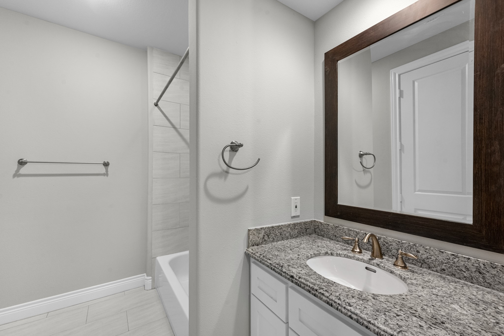 3414 Center Street Houston, TX 77007 - Photo 29 of 35 a bathroom with a granite countertop sink and a mirror