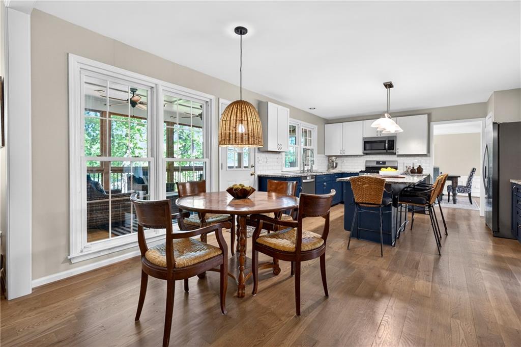 7830 Llangollen Way Cumming, GA 30041 - Photo 11 of 60 a dining room with furniture a chandelier and wooden floor