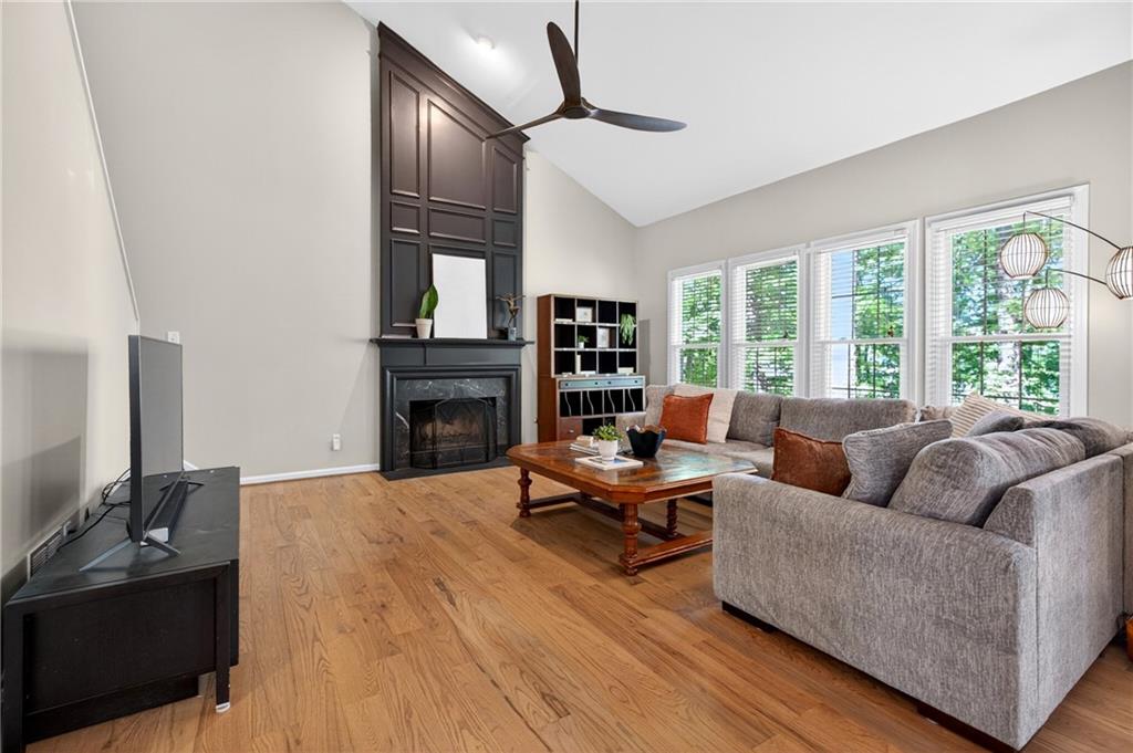 7830 Llangollen Way Cumming, GA 30041 - Photo 13 of 60 a living room with furniture fireplace and a large window