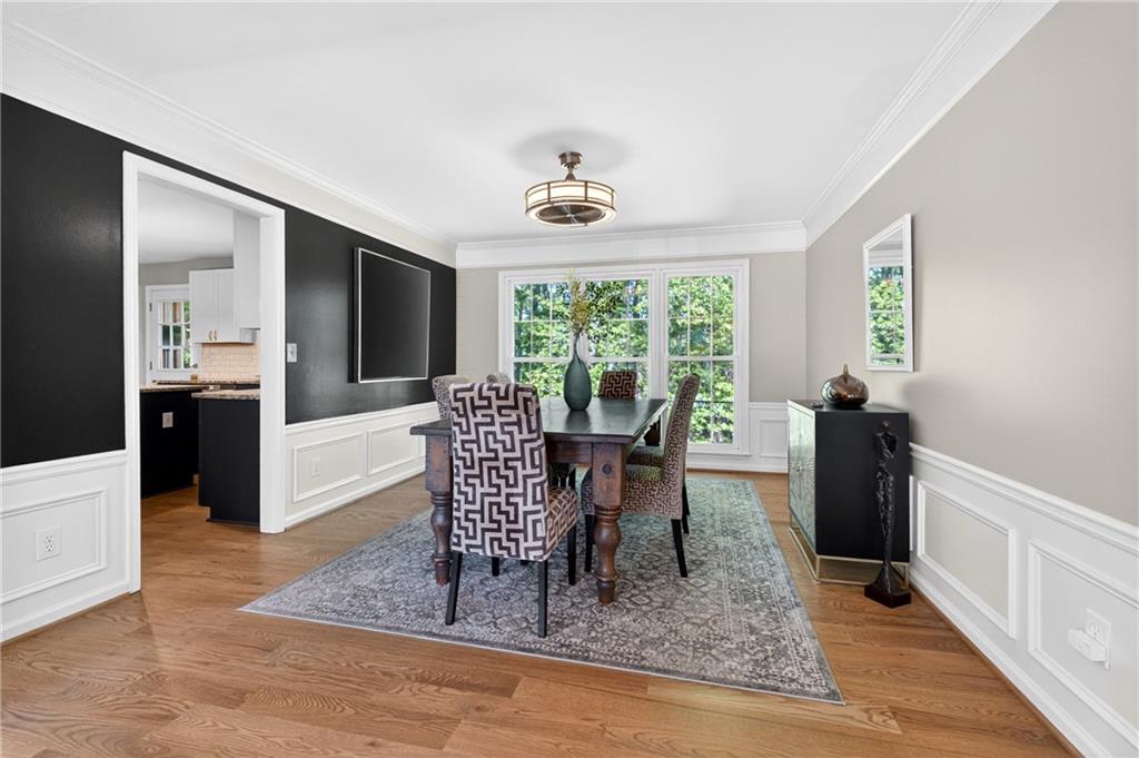 7830 Llangollen Way Cumming, GA 30041 - Photo 21 of 60 a view of a dining room with furniture window and wooden floor