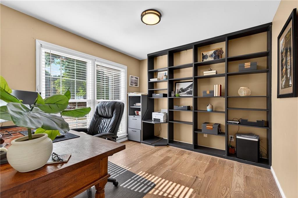 7830 Llangollen Way Cumming, GA 30041 - Photo 22 of 60 a living room with furniture a window and a potted plant