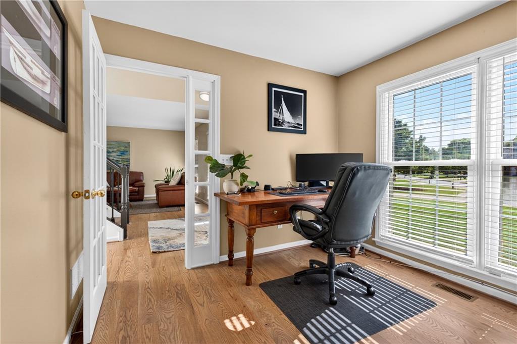 7830 Llangollen Way Cumming, GA 30041 - Photo 23 of 60 a view of a workspace with furniture and a window