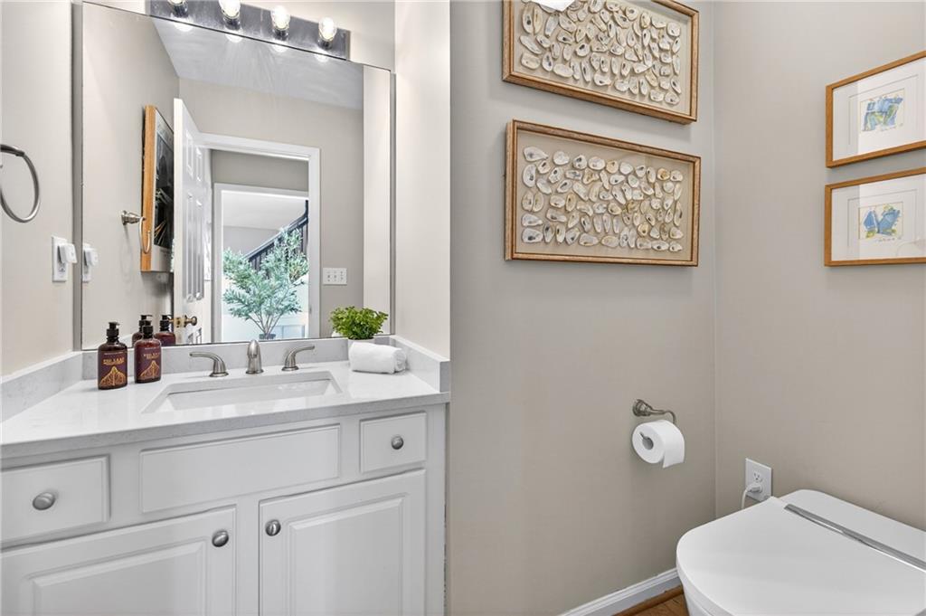 7830 Llangollen Way Cumming, GA 30041 - Photo 26 of 60 a bathroom with a toilet sink and mirror