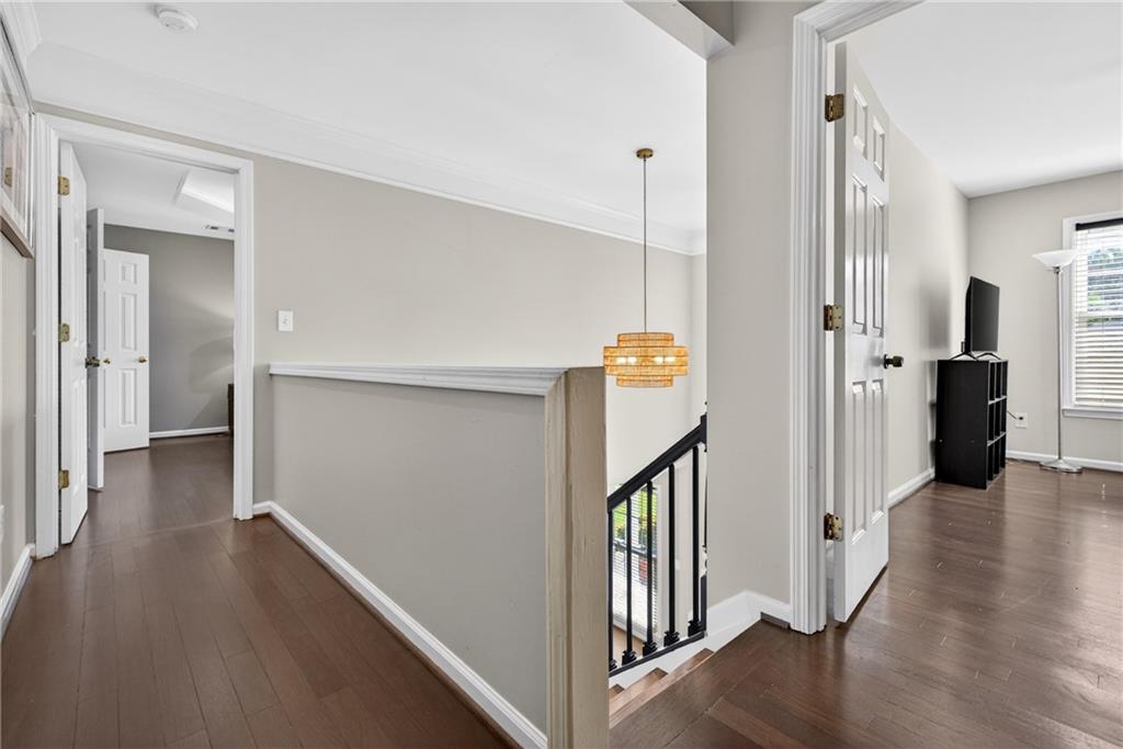 7830 Llangollen Way Cumming, GA 30041 - Photo 27 of 60 a view of a hallway with wooden floor and staircase