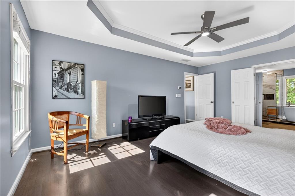 7830 Llangollen Way Cumming, GA 30041 - Photo 30 of 60 a bedroom with a bed and a flat screen tv