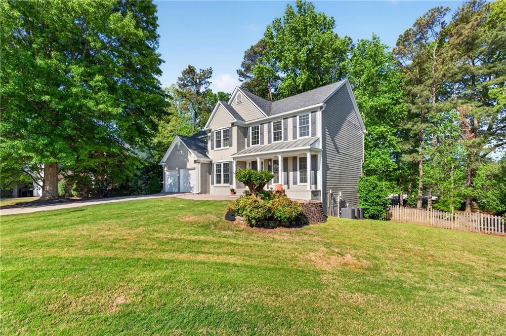 7830 Llangollen Way Cumming, GA 30041 - Photo 3 of 60 a front view of a house with a yard