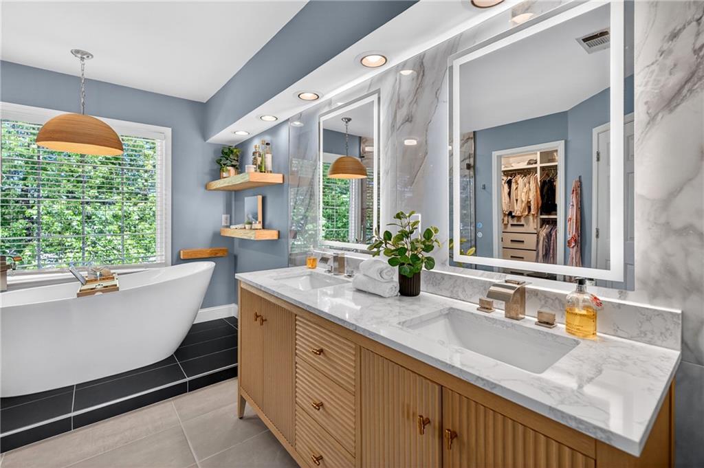 7830 Llangollen Way Cumming, GA 30041 - Photo 33 of 60 a bathroom with a granite countertop sink and a large mirror