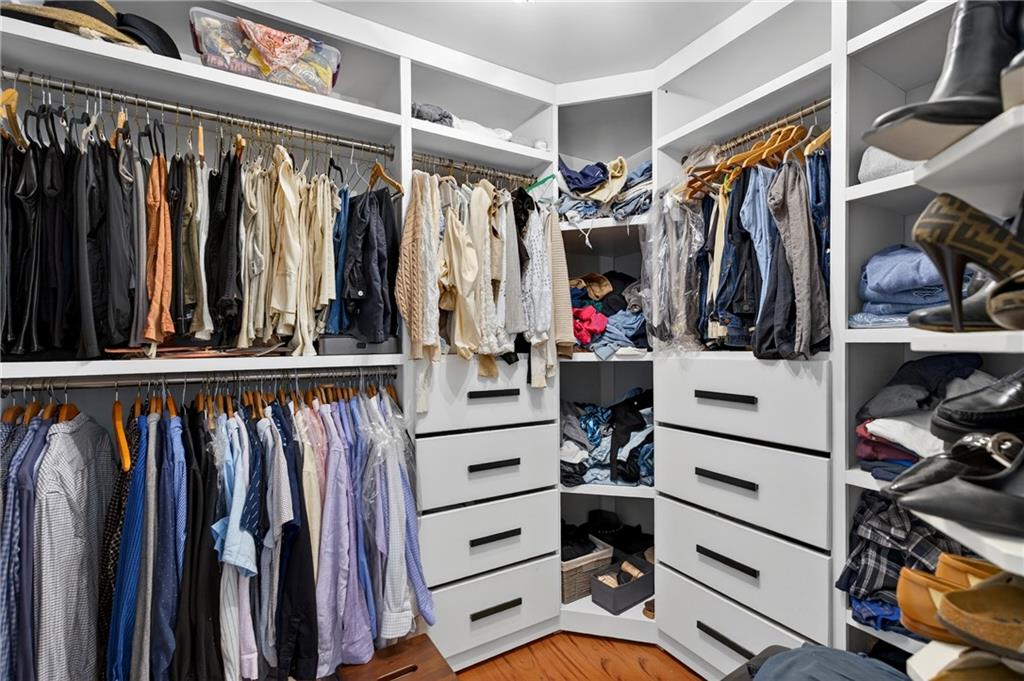 7830 Llangollen Way Cumming, GA 30041 - Photo 36 of 60 a view of walk in closet with clothes and shoes