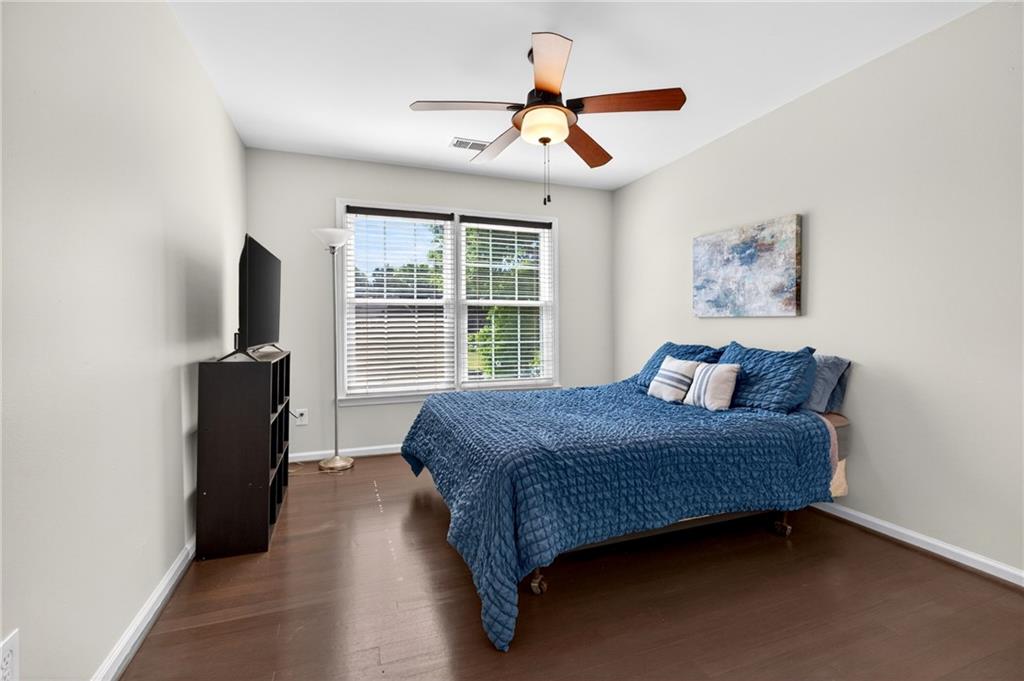 7830 Llangollen Way Cumming, GA 30041 - Photo 37 of 60 a bedroom with a bed and a flat tv screen on a dresser