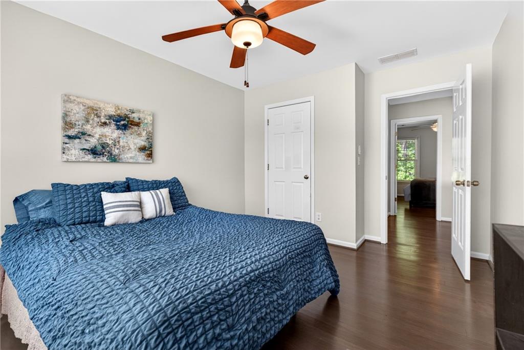 7830 Llangollen Way Cumming, GA 30041 - Photo 38 of 60 a bedroom with a large bed and a chandelier