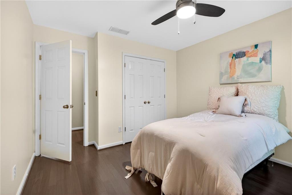 7830 Llangollen Way Cumming, GA 30041 - Photo 40 of 60 a bedroom with a bed and a chandelier