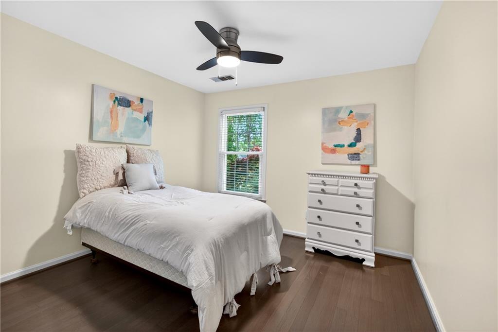 7830 Llangollen Way Cumming, GA 30041 - Photo 41 of 60 a bedroom with a bed and a chandelier