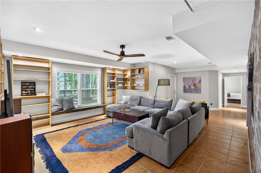 7830 Llangollen Way Cumming, GA 30041 - Photo 45 of 60 a living room with furniture large windows and wooden floor