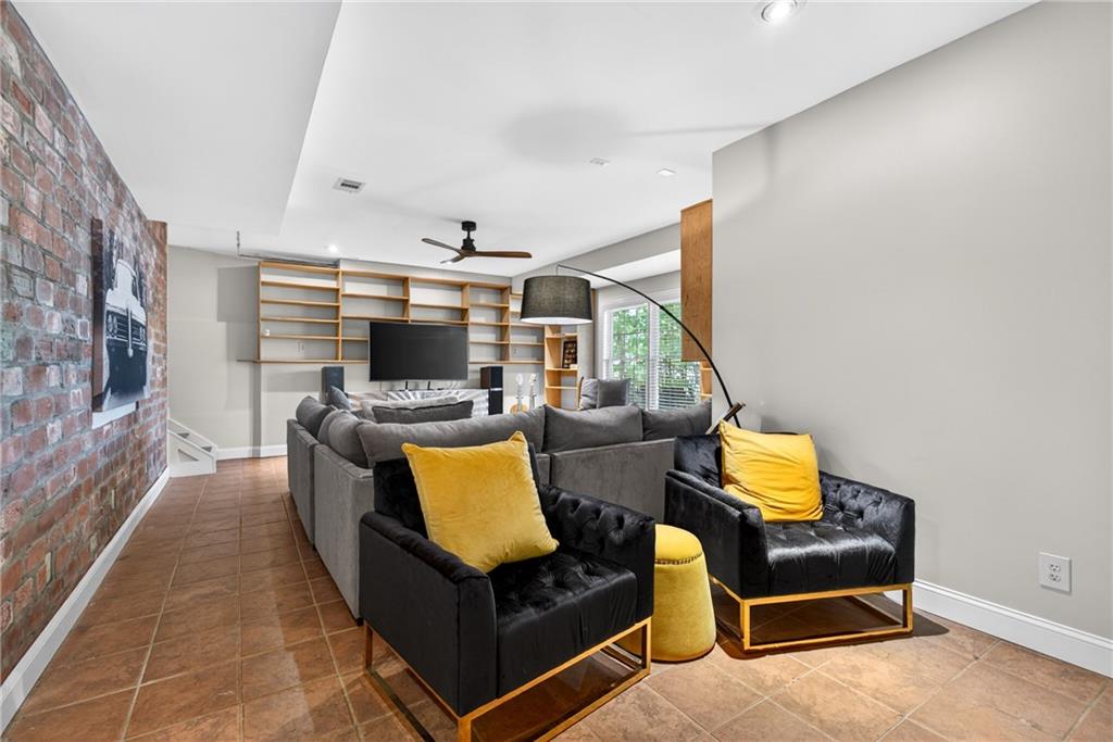 7830 Llangollen Way Cumming, GA 30041 - Photo 47 of 60 a living room with furniture and a flat screen tv