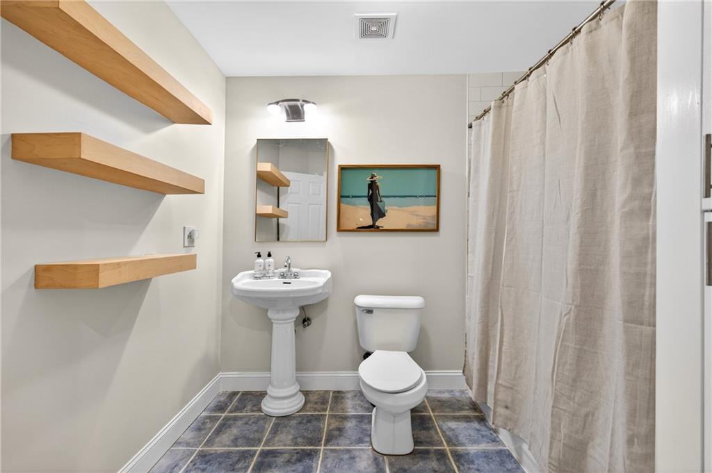 7830 Llangollen Way Cumming, GA 30041 - Photo 48 of 60 a bathroom with a sink a toilet and mirror