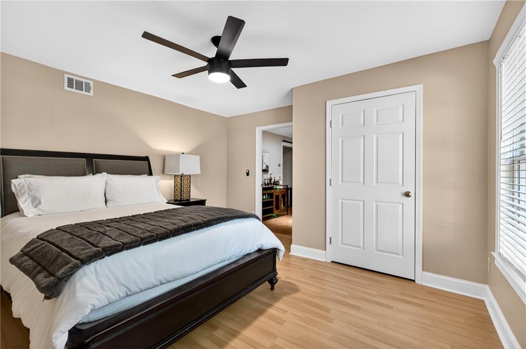 7830 Llangollen Way Cumming, GA 30041 - Photo 49 of 60 a bedroom with a bed and a ceiling fan