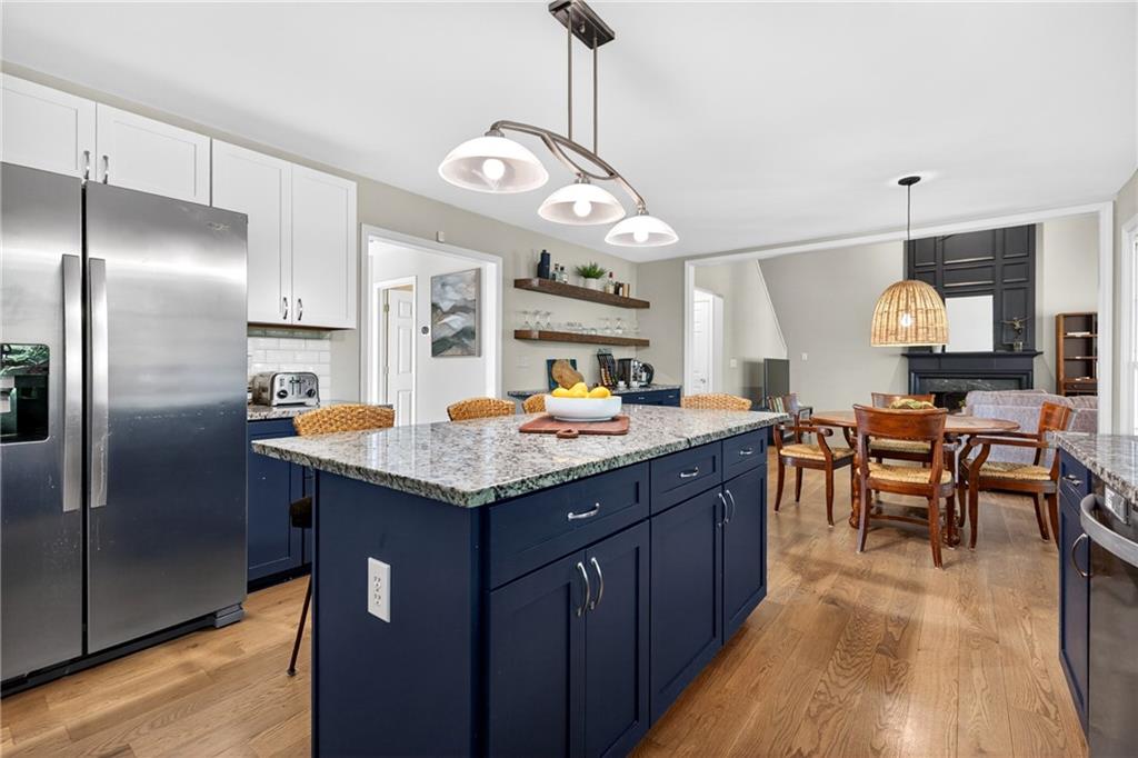 7830 Llangollen Way Cumming, GA 30041 - Photo 7 of 60 a kitchen with granite countertop cabinets a sink and stainless steel appliances