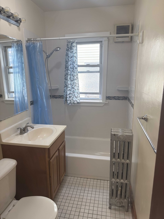 3965 Washington Street Boston, MA 02131 - Photo 12 of 18 a bathroom with a sink toilet vanity and tub
