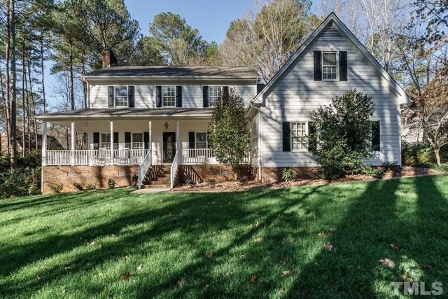 a front view of a house with a yard table and chairs
