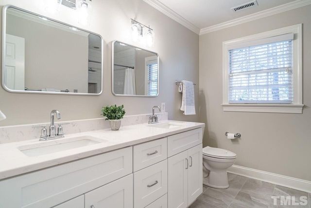 a bathroom with a shower and a sink