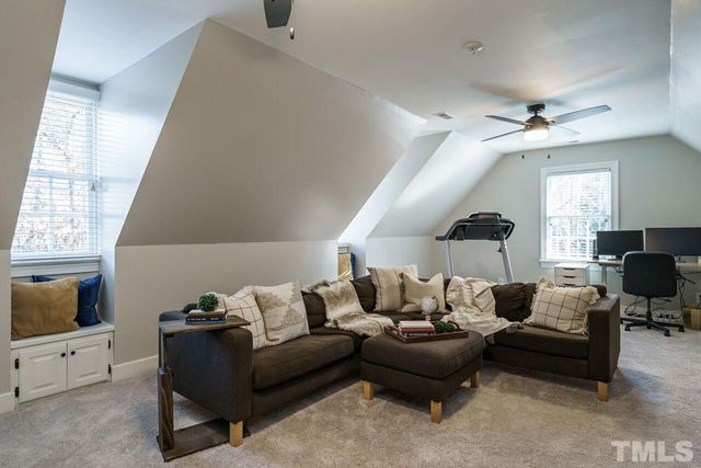 a living room with furniture hard wood floor and a window