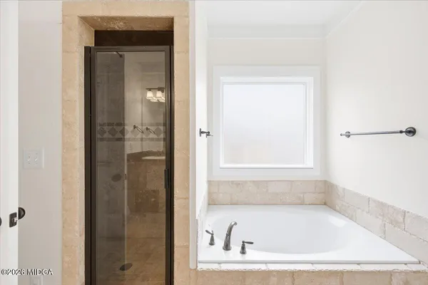a white bath tub sitting next to a window