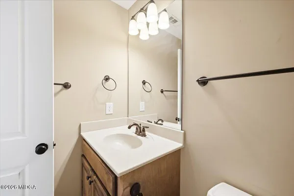 a bathroom with a sink vanity mirror and shower