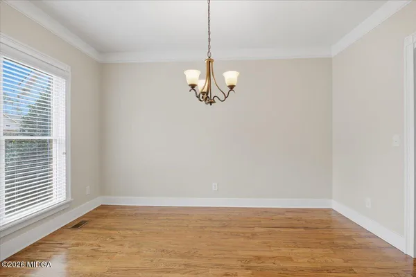 a view of a room with wooden floor and window