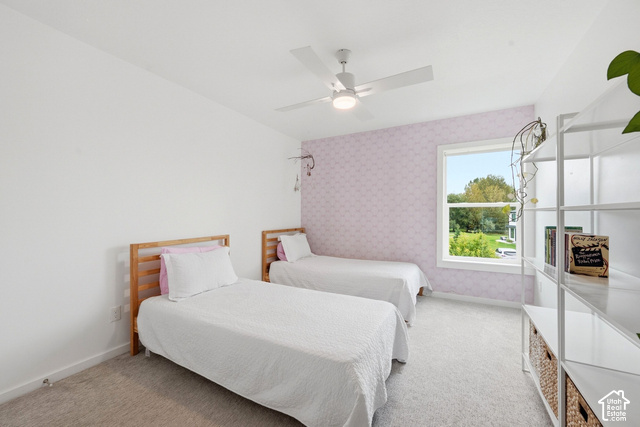 1295 North Canyon View Road Midway, UT 84049 - Photo 39 of 52 Window with exterior scenery, overhead ceiling fan, white walls, patterned accent wall, and light-colored carpeting